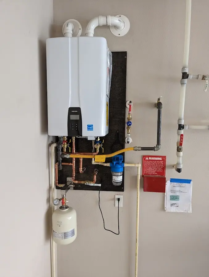 Professional plumber installing copper piping in a New Freedom home